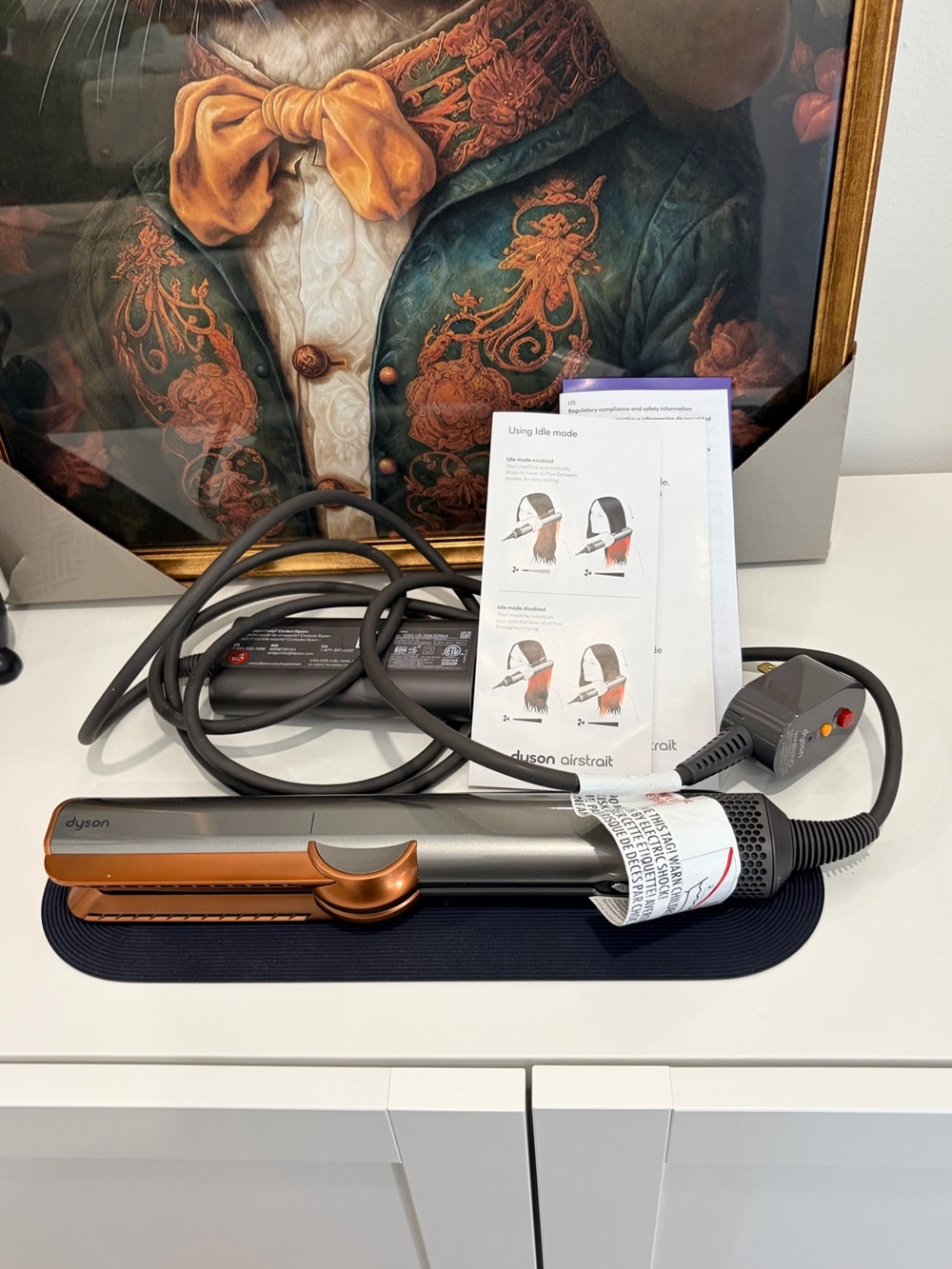 Dyson Airstrait Straightener. Bright nickel and rich copper colour.